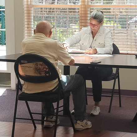 Act Now Foundation staff member conducting a free memory screening for a senior.